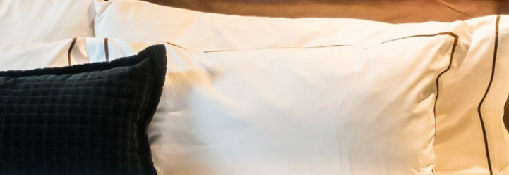 Comfortable hotel bed with soft lighting